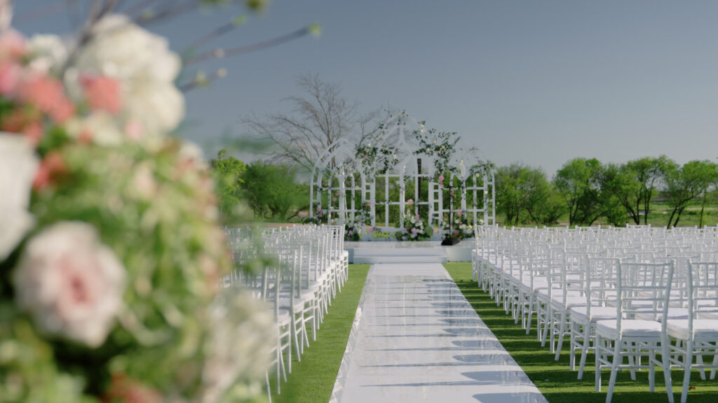 Chairs line an aisle prepared for a wedding outside in Boston, MA.