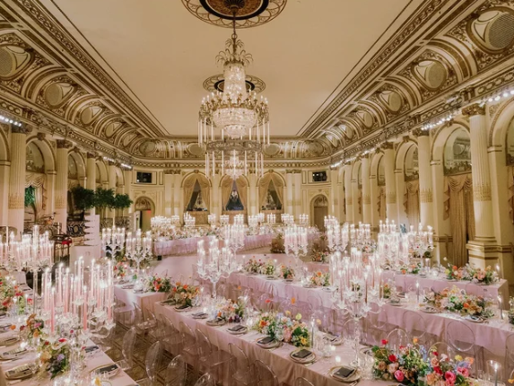 Wedding set up by Jove Meyer, an elite Boston wedding planner, which includes an expansive elegant space with candlelit tablescapes.