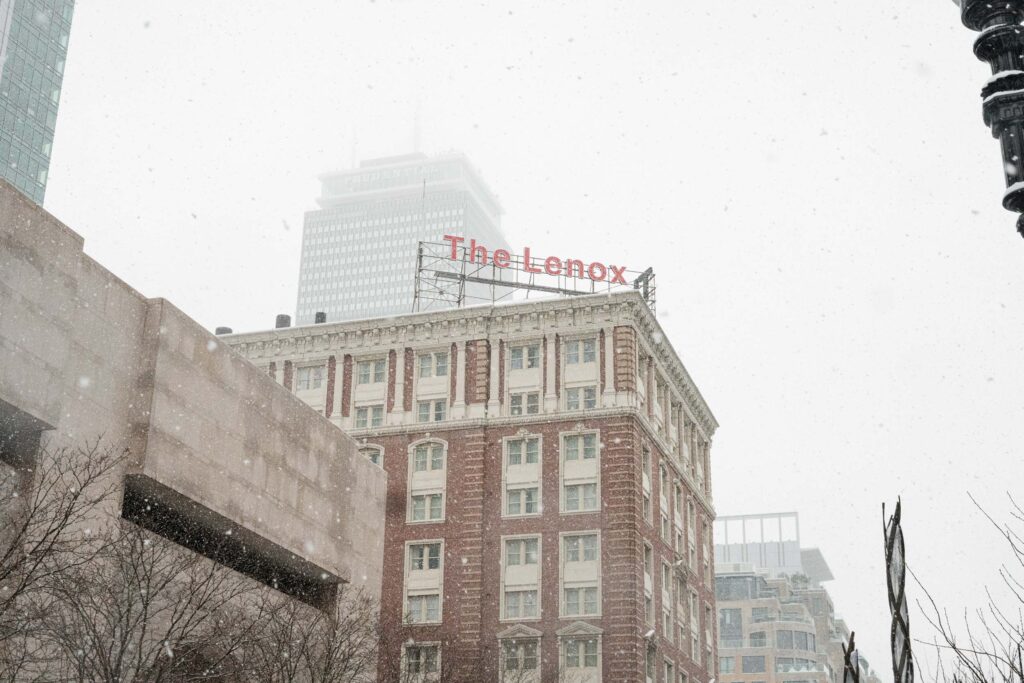 An exterior photo of the Lenox Hotel in the snow on a winter day.