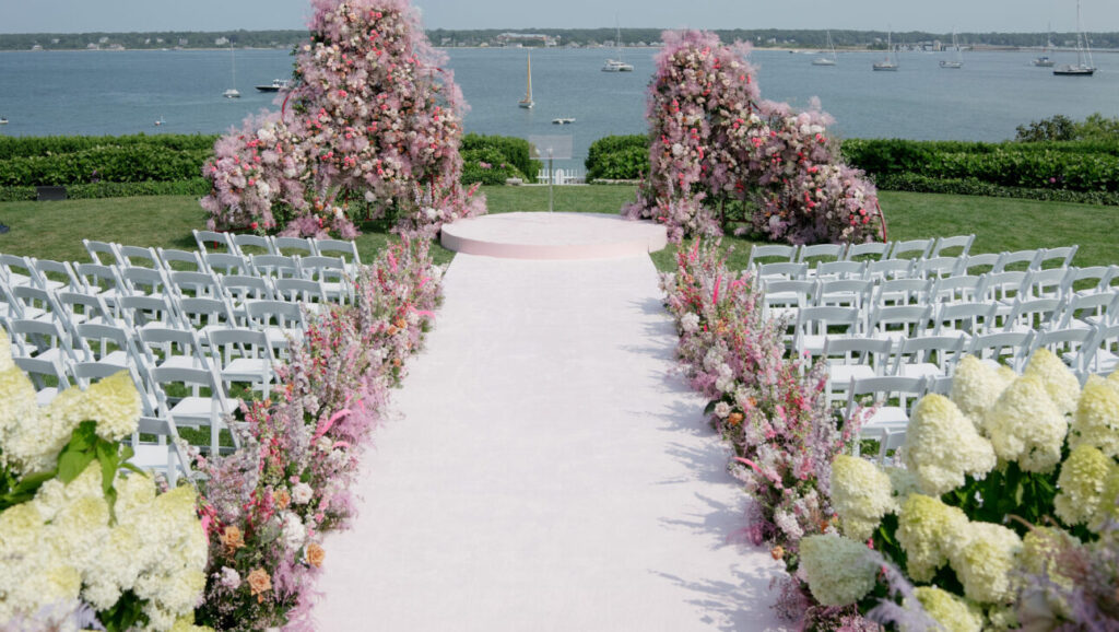 Rafanelli Events wedding set up in Cape Cod, with an aisle lined by elaborate florals.