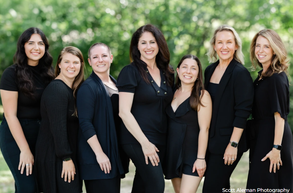 Wedding planners of Significant Event of Texas standing and smiling together.