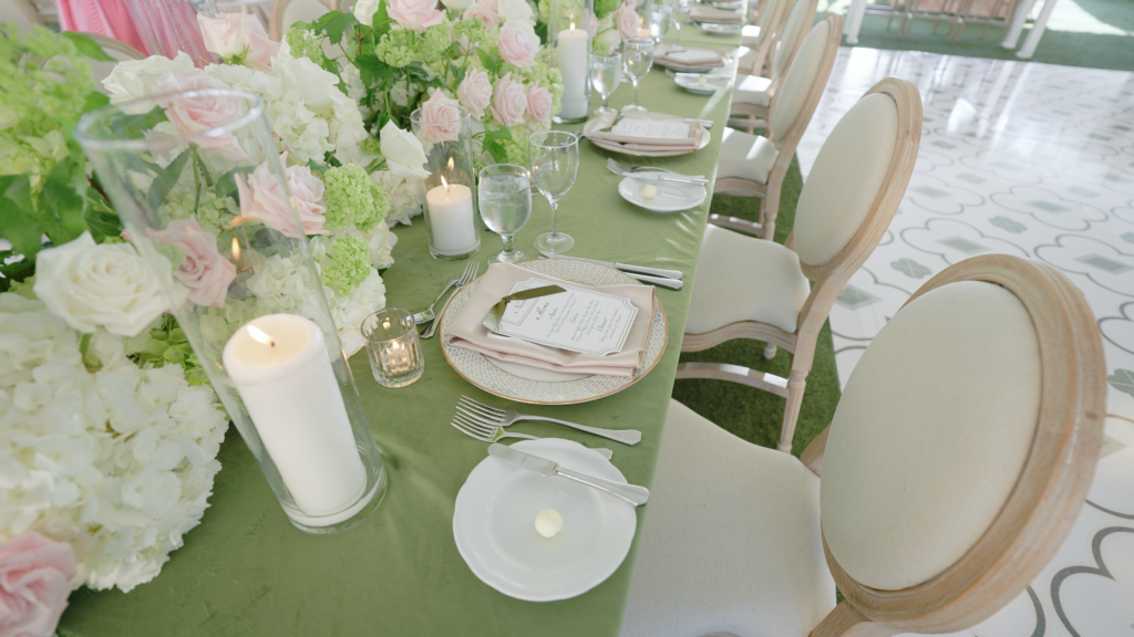 Wedding reception tablescape at Wychmere Beach Club featuring elegantly styled place settings, soft candlelight, and refined coastal décor creating a sophisticated and romantic dining atmosphere.