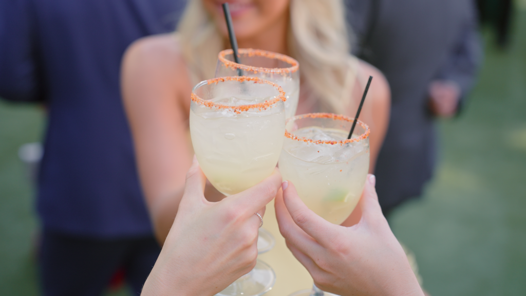 Bridal party has a moment to cheers with their cocktails before the wedding.