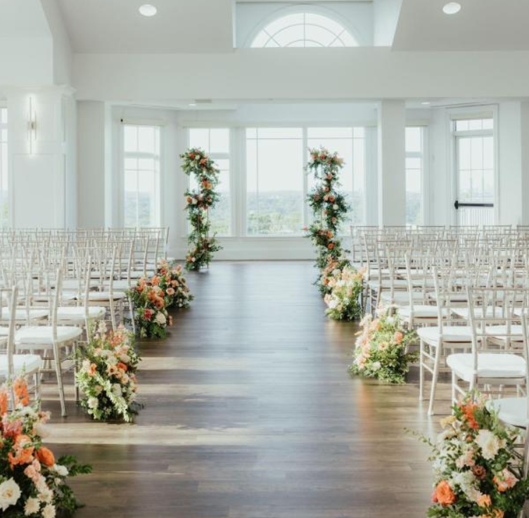 Sophisticated indoor wedding setup at Granite Links Golf Club with round tables, soft lighting, and a polished ceremony atmosphere in Quincy Massachusetts