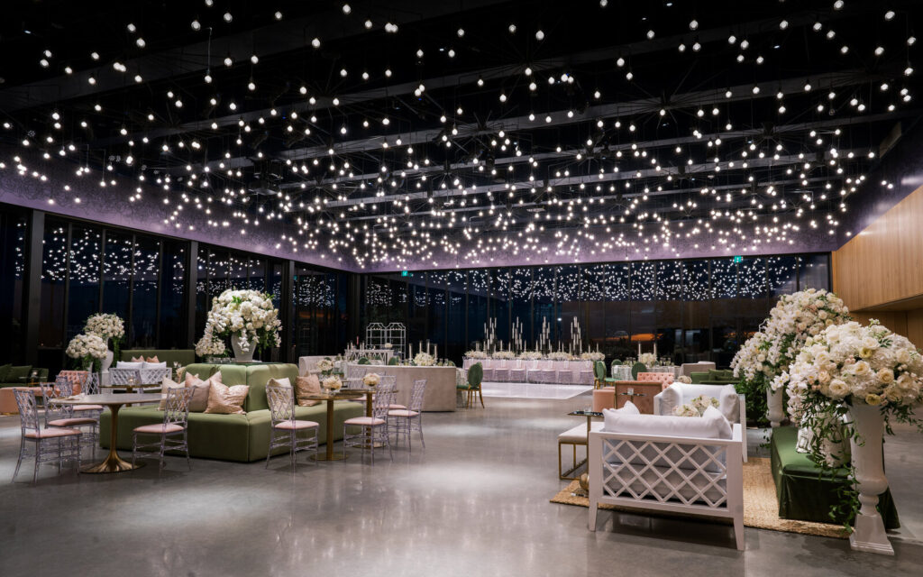 Interior of Hall of Lights featuring glowing illuminated installations, elegant floral arrangements, and a modern, immersive event space designed for a visually striking wedding atmosphere.