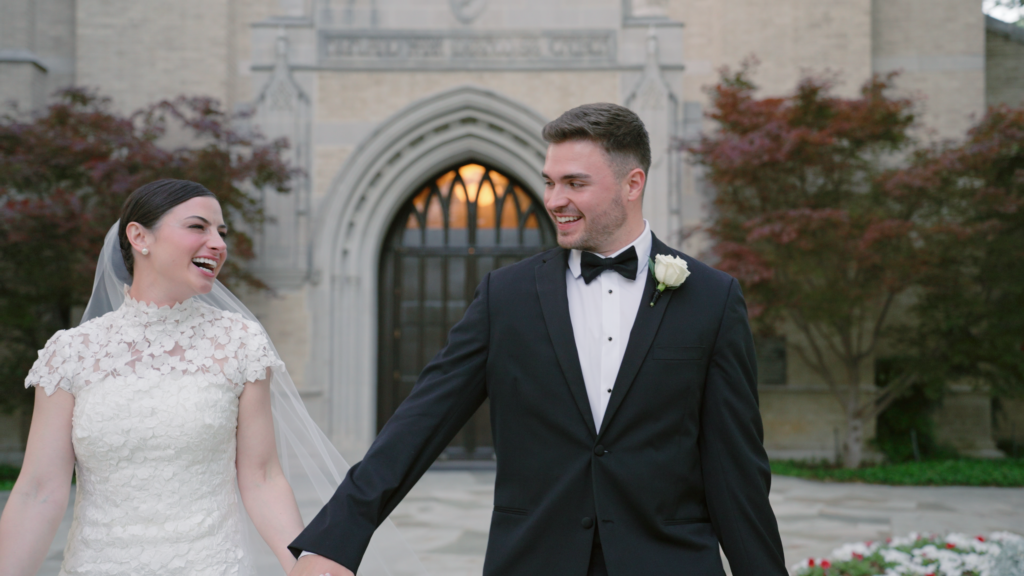 Bride and groom laughing gleefully outside of their church venue at their Boston wedding.