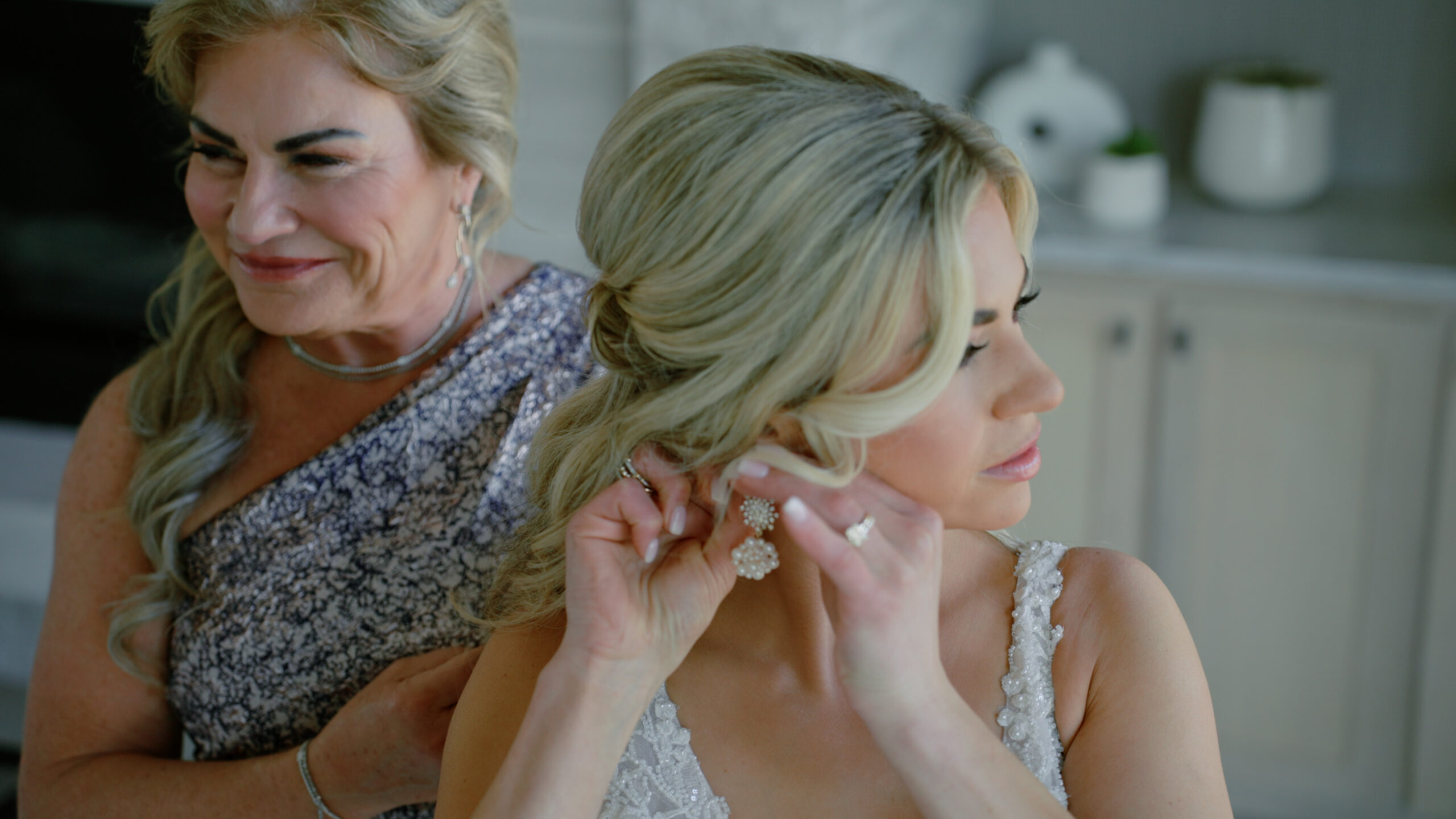 Bride putting on earrings before her wedding at Bella Donna Chapel, captured in an intimate pre-ceremony moment.