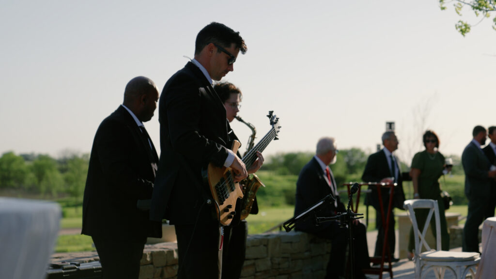 Live band performing at an outdoor wedding at Hotel Drover in Fort Worth, Texas, capturing an energetic celebration with guests dancing and a rustic luxury Western backdrop.