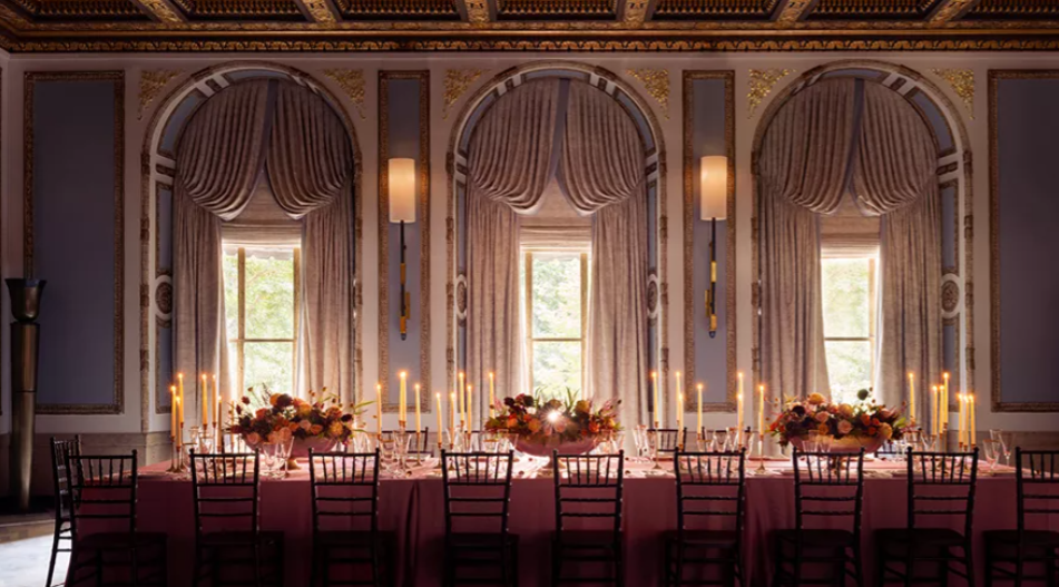 Candlelit wedding reception setup inside the Wyeth Room at The Langham, Boston, featuring elegant tablescapes, soft ambient lighting, and refined architectural details.