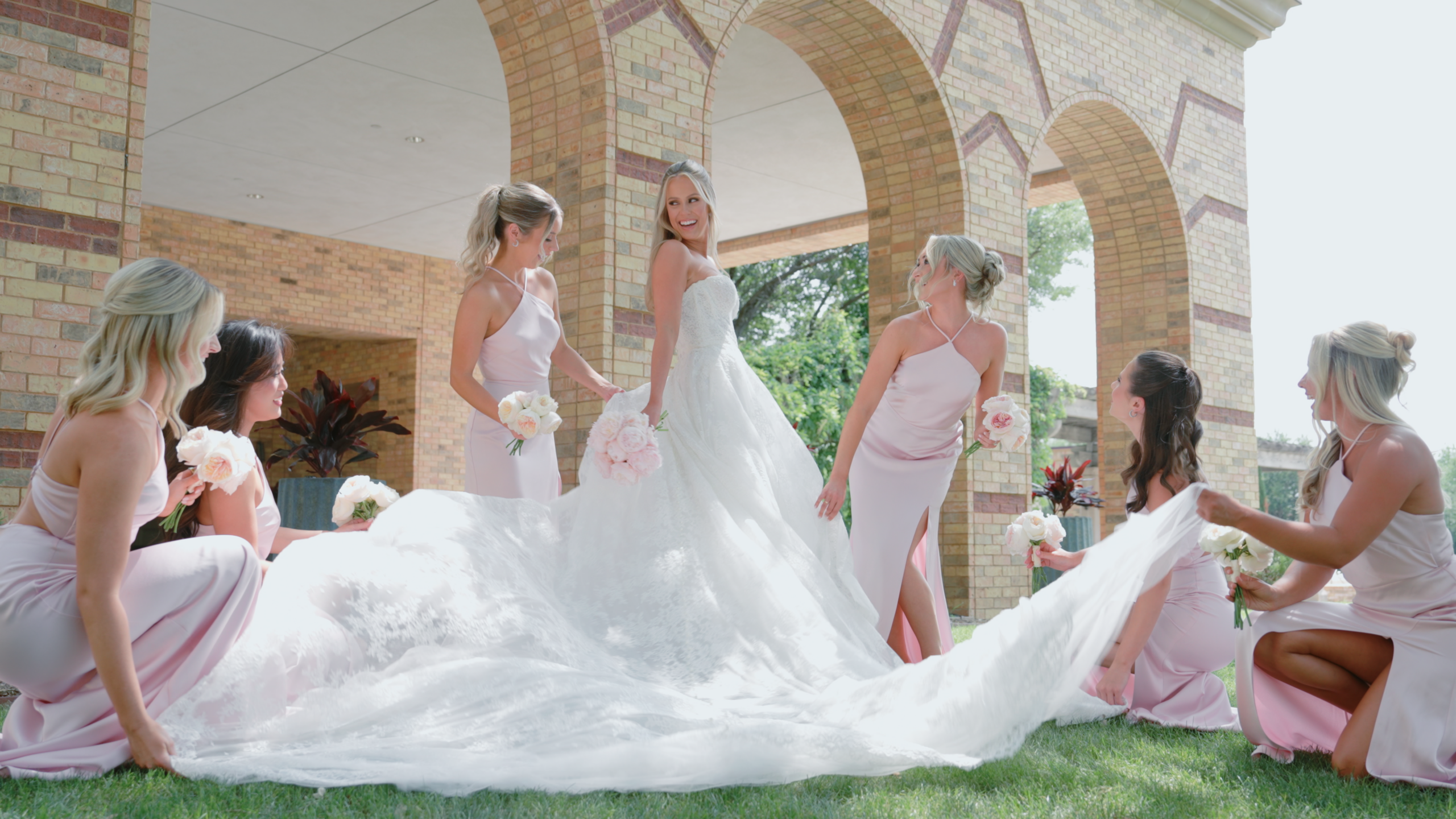 Bride and her bridesmaids standing around her at her wedding venue in Boston, MA.