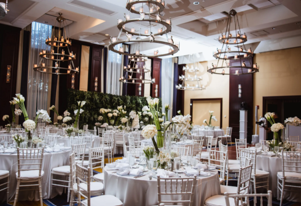 Sophisticated wedding reception design inside The Liberty Hotel in Boston with round tables and neutral tones.