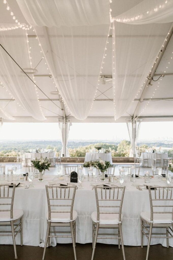 Elegant indoor wedding reception setup at Granite Links Golf Club featuring refined table settings and modern event design overlooking Boston views.